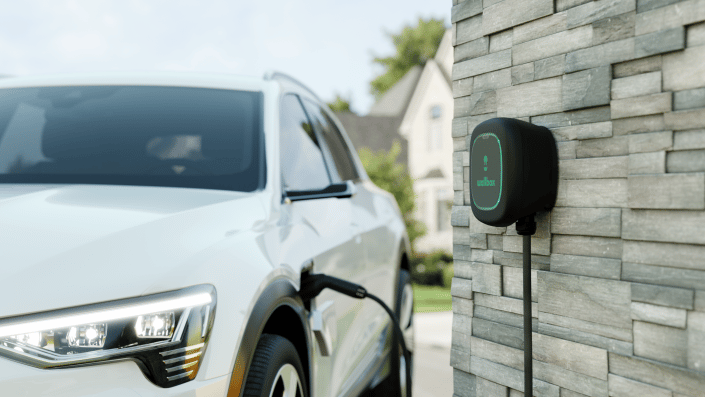 wallbox ev charger plugged into white vehicle