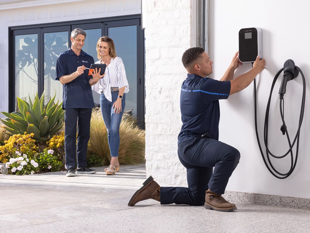 EV charging installer outside home.