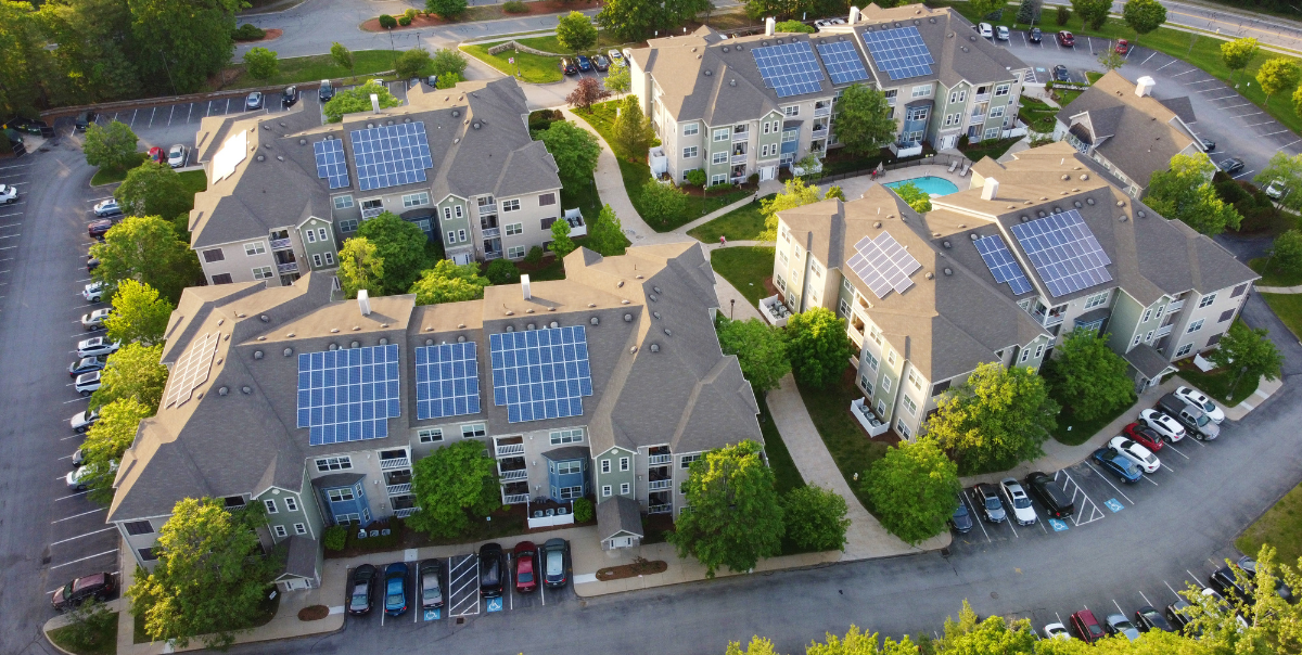 equitable ev ownership is critical for a green future. a multifamily community benefits from electrification technologies like ev charging and solar panels, also increasing ev charging security and resulting ev adoption. electrification is good for business.