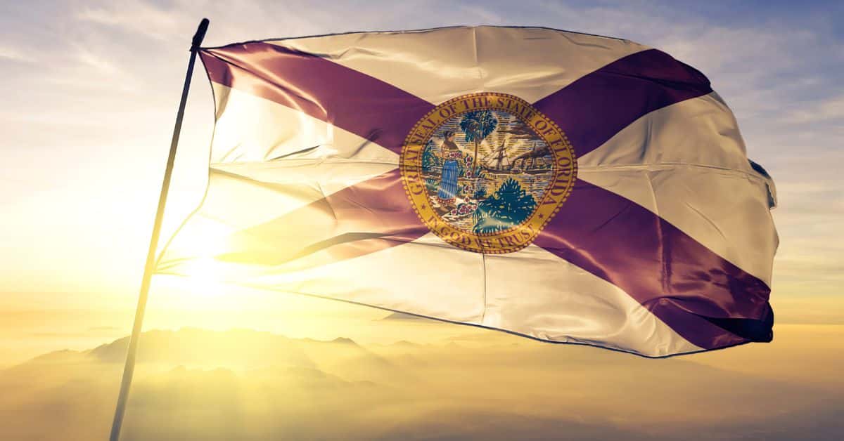 The Florida state flag waving prominently, symbolizing the growth and commitment to Florida EV charging infrastructure and its role in sustainable transportation