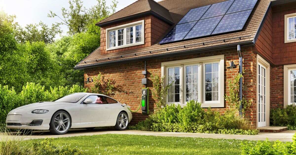 An electric vehicle charging outside a house with installed solar panels, illustrating the harmonious integration of renewable energy for residential homes and sustainable transportation