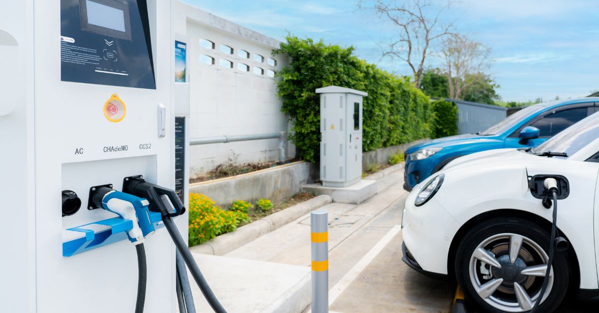 An electric vehicle plugged in and charging on a parking, illustrating the integration of energy storage solutions in commercial EV charging systems