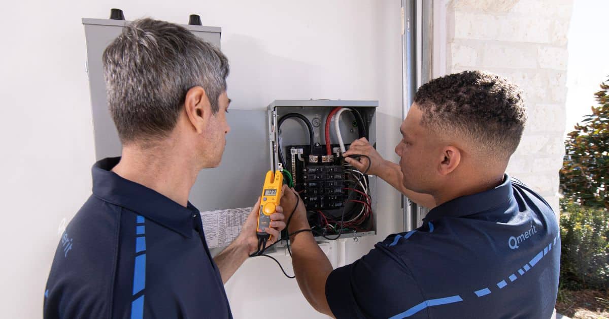 Two electrical contractors working on panel upgrades, emphasizing the key benefits these enhancements bring to a property in terms of safety, efficiency, and overall value