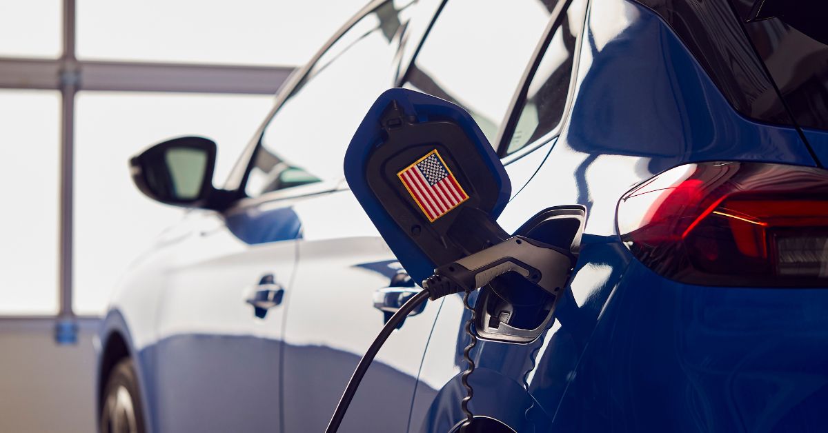 Zero emission electric car with US flag sticker, highlighting government policies influencing EV adoption rates