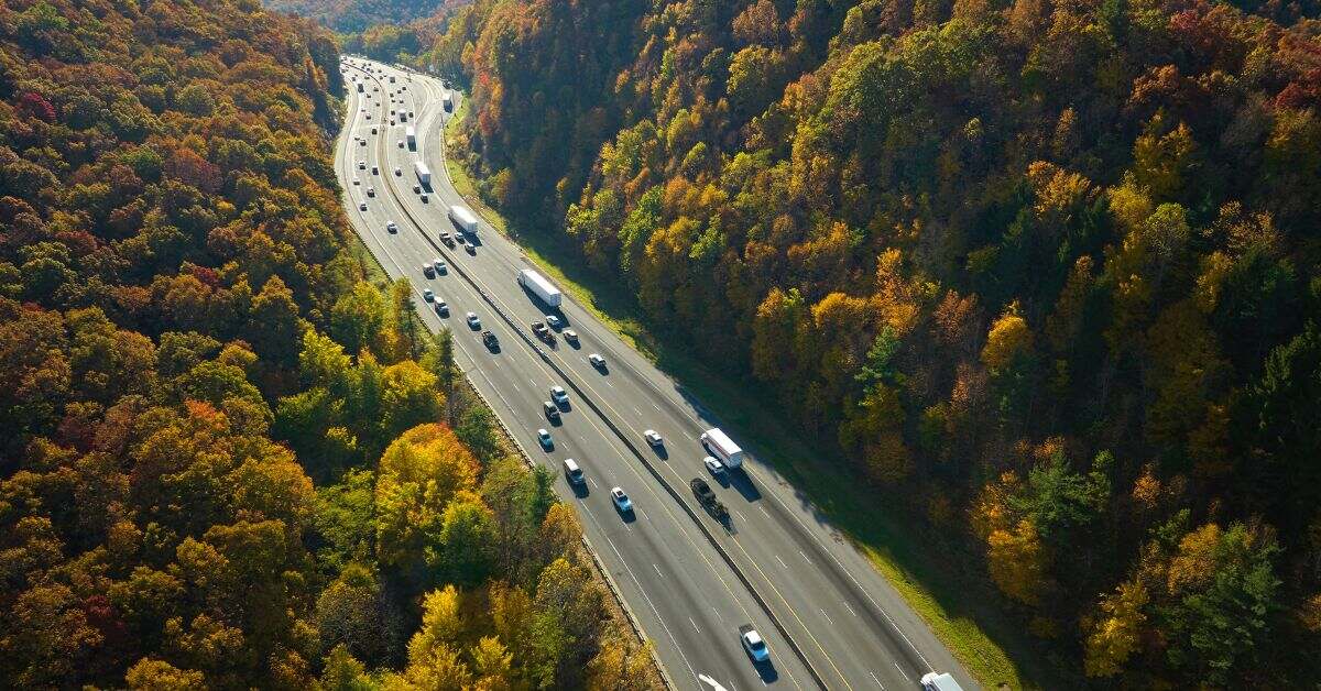 Snapshot of a bustling highway with vehicles in motion, symbolizing the latest electric car statistics and charging trends in 2024